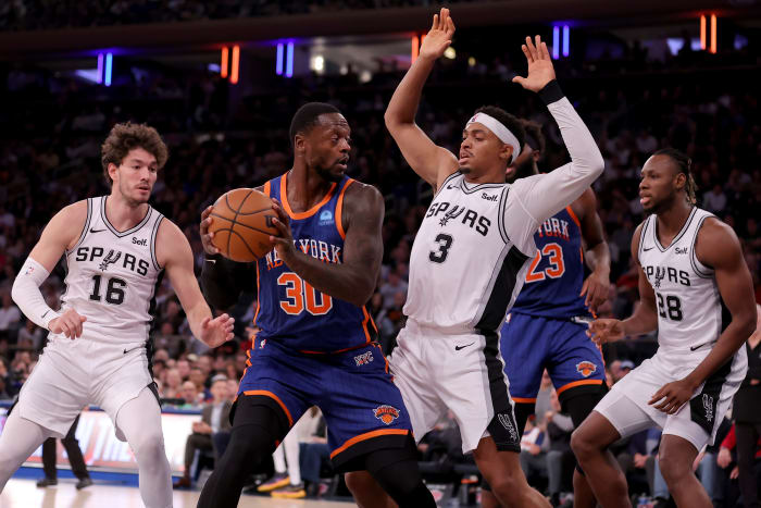 New York Knicks forward Julius Randle (30) controls the ball against San Antonio Spurs forwards Cedi Osman (16) and Keldon Johnson (3) and center Charles Bassey (28) during the third quarter at Madison Square Garden.